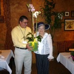Steve presenting orchids to newly reelected President Denyse Jenkins